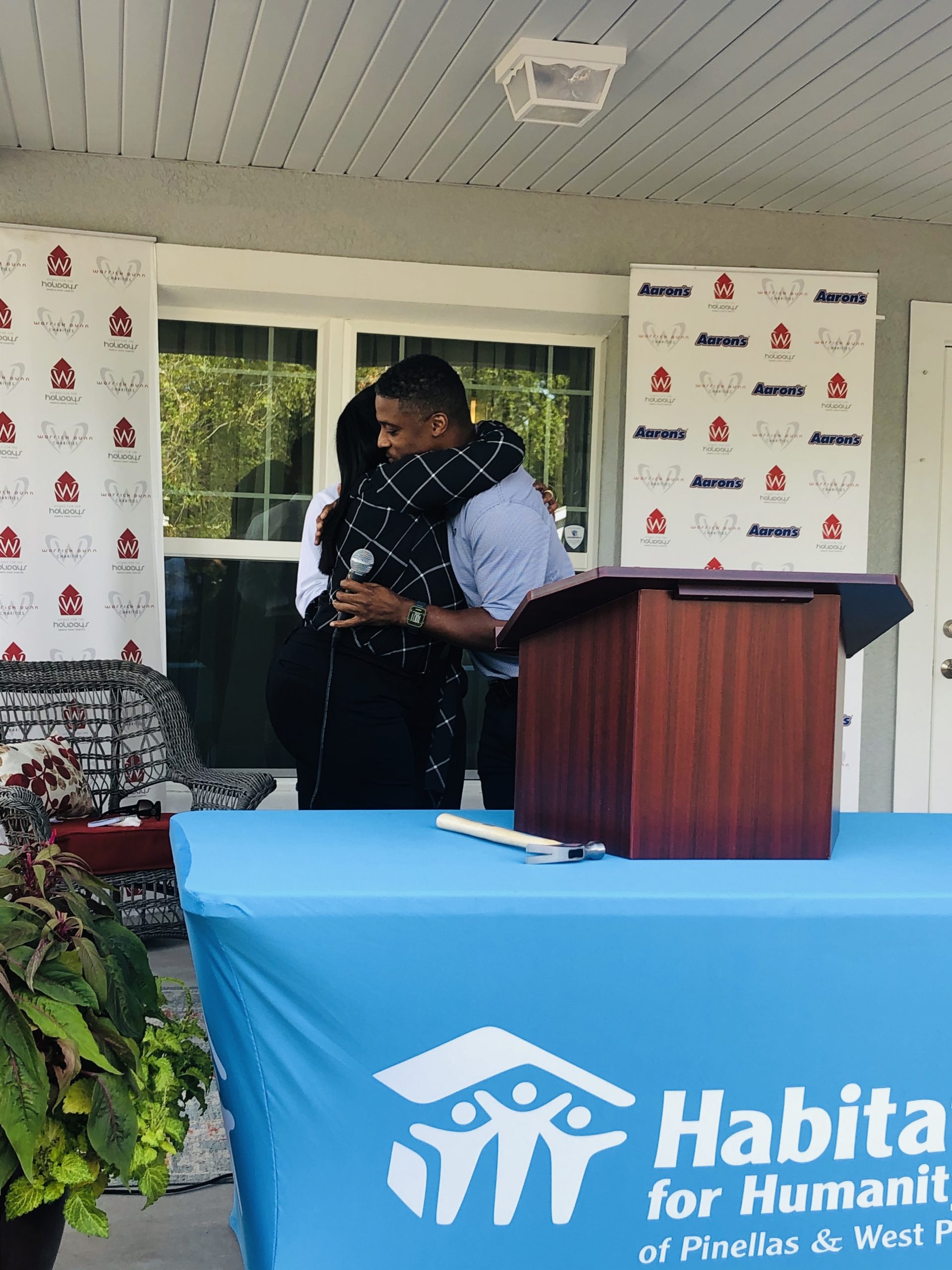 Ex-NFL star Warrick Dunn helps deliver 173rd home to single parent as part of his charity