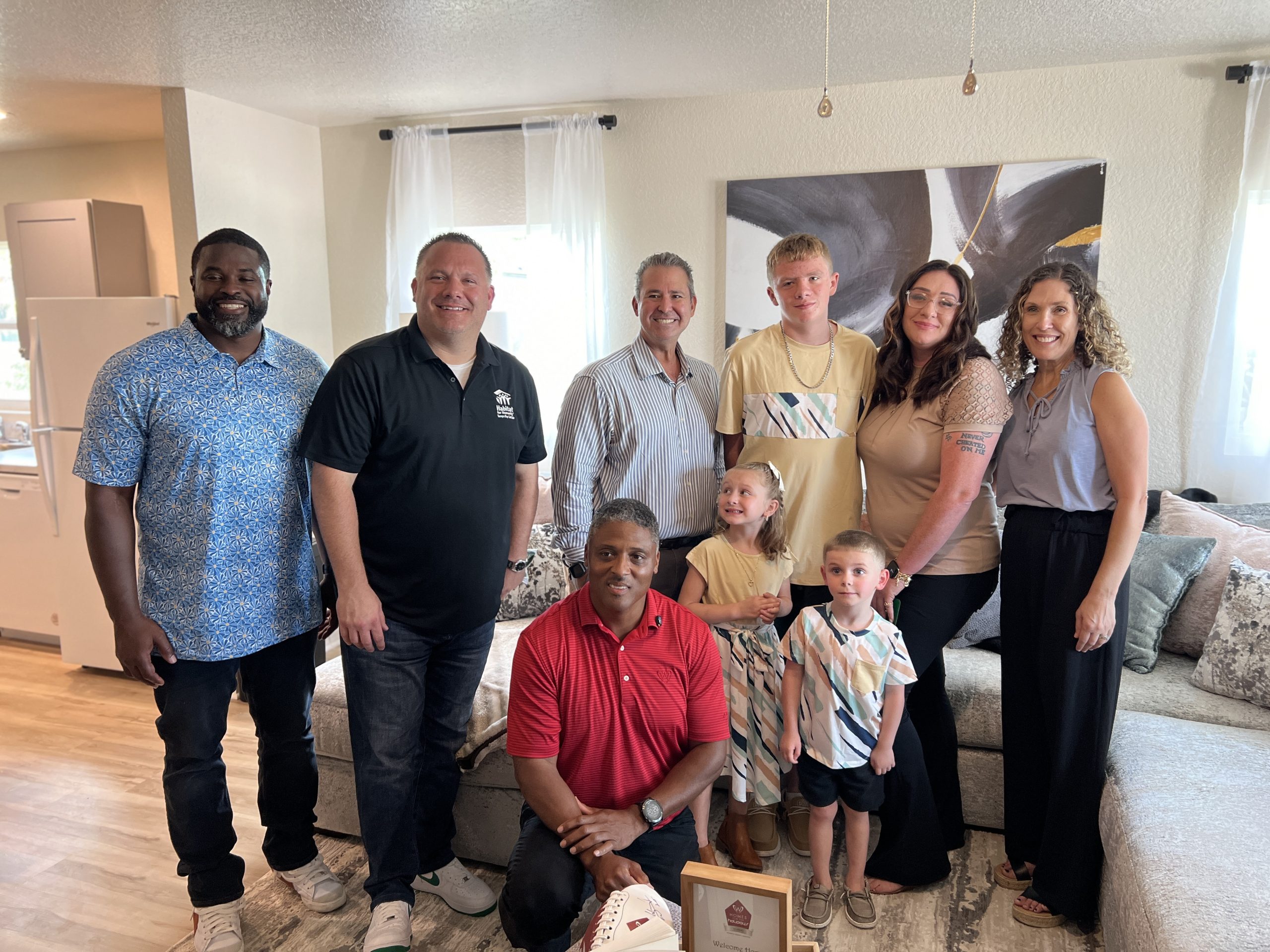 NFL Great Warrick Dunn surprises Habitat families with furniture